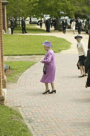 Her Majesty Queen Elizabeth II in bright purple outfit and black purse, walking from Governor's Palace in Williamsburg Virginia, as part of the 400th anniversary of the English Settlement of Jamestown, Virginia, May 4, 2007のeditorial素材