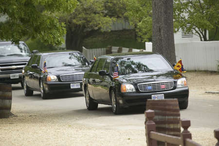 Black Presidential Limo and American Flag and motorcade pulling up in front of Governor's Palace in Williamsburg, Virginia on May 4, 2007 のeditorial素材