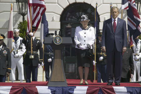 President George W. Bush and Queen Elizabeth II standing at attention during the National Anthem on the South Lawn of the White House for the May 7, 2007 Official State Welcoming of Her Majesty Queen Elizabeth II and Prince Philip, the Duke of Edinburgh tのeditorial素材