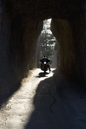 Motorcyclist driving through tunnel on Needles Highway, Black Hills, near Mount Rushmore National Memorial, South Dakotaのeditorial素材