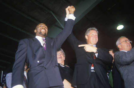 Governor Bill Clinton joins hands with Boxer Tommy Heams during a Detroit campaign rally in 1992 on his final day of campaigning in Detroit, Michiganのeditorial素材