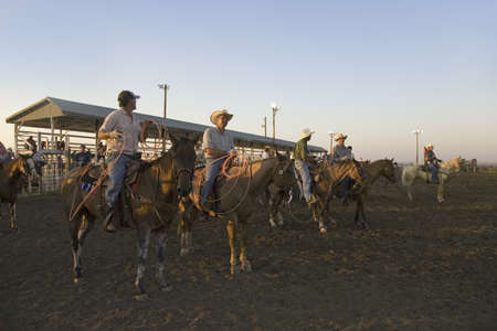 Cowboys at sunset at PRCA Rodeo at Lower Brule, Lyman County, Lower Brule Sioux Tribal Reservation, South Dakota, 58 miles Southeast of Pierre near Missouri River, August 10, 2007のeditorial素材