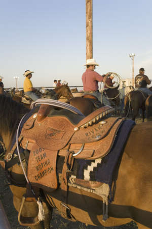 Close-up of saddle and cowboy at PRCA Rodeo at Lower Brule, Lyman County, Lower Brule Sioux Tribal Reservation, South Dakota, 58 miles Southeast of Pierre near Missouri River, August 10, 2007のeditorial素材