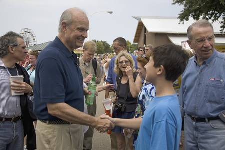 Former U.S. Senator and actor of Law & Order, Fred Thompson shaking boys hand and U.S. Senator from Iowa, Republican Chuck Grassley, at Iowa State Fair to campaign for U.S. President, August 17, 2007, Des Moines, Iowaのeditorial素材