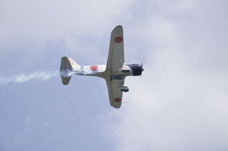 Japanese Zero is hit in a reenactment flight of World War II battles at Mid-Atlantic Air Museum World War II Weekend and Reenactment in Reading, PA held June 18, 2008のeditorial素材
