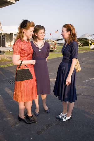 Three women wearing old fashioned 1940s dresses at Mid-Atlantic Air Museum World War II Weekend and Reenactment in Reading, PA held June 18, 2008のeditorial素材