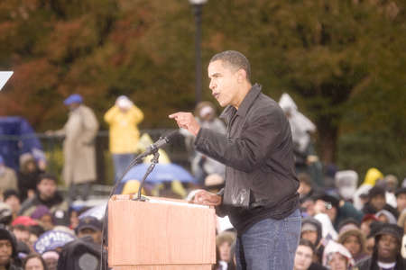 US Senator Barack Obama speaking at podium in pouring rain at Presidential Rally on October 28, 2008, at Widener University in Chester, PAのeditorial素材