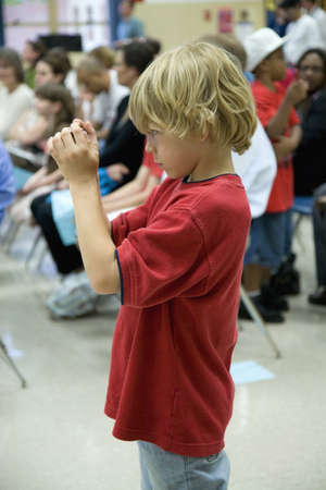 Blond haired boy in red t-shirt taking picture with digital camera at Ravensworth Elementary,...