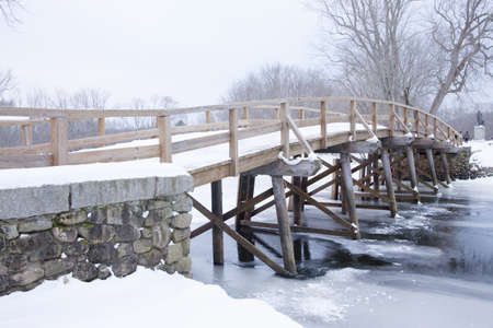 Old North Bridge in winter snow, Concord River, Concord, Ma., New England, USA, the historical site of the Battle of Concord, the first day of battle in the American Revolutionary Warのeditorial素材