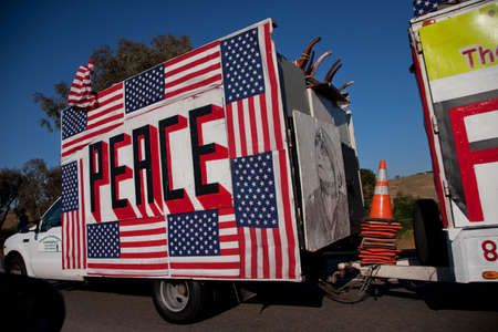 A truck decorated with US flags, the word peace and an illustrated portrait of a woman のeditorial素材