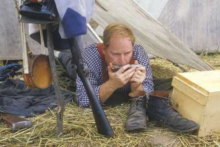 Confederate participant in camp scene playing mouth harp during recreation of Battle of Manassas, marking the beginning of the Civil Warのeditorial素材