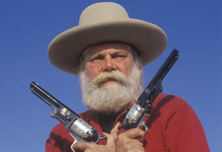 Old West gunslinger drawing guns during historical reenactment, CAのeditorial素材