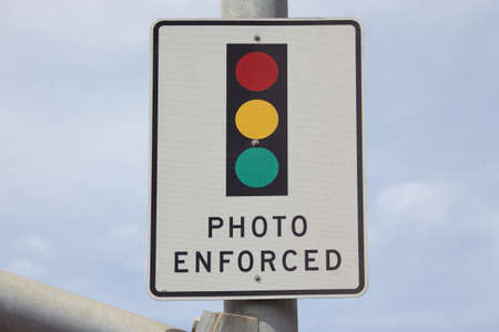 Photo Enforced signage above traffic lightの写真素材