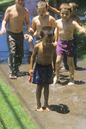 Boys playing with water balloons, San Bernardino, CAのeditorial素材