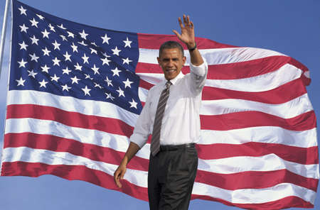 President of the United States, Barack Obama waving with background of flag of the United States of Americaのeditorial素材