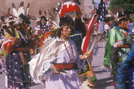 Native American woman in full costume performing Corn Dance ceremony in Santa Clara Pueblo, NM