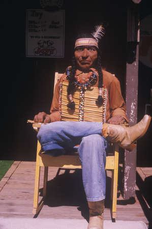 Wood carving of Native American dressed in blue jeans, ORのeditorial素材