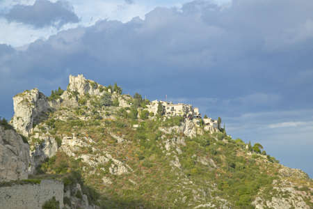 Looking up at Town of La Turbie with Trophee des Alpes and church, Franceのeditorial素材