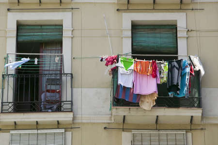 Laundry hangs in window of old section of Barcelona, Spainのeditorial素材