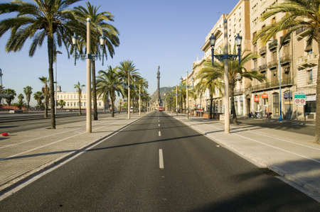 Statue of Christopher Columbus overlooks roadway on Passeig de Colom, next to waterfront of Port Vell, Barcelona, Spainのeditorial素材