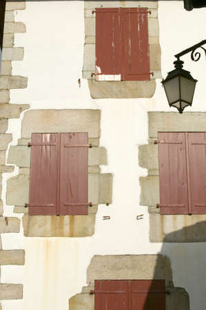Red shutter windows of Sare, France in Basque Country on Spanish-French border, a hilltop 17th century village surrounded by farm fields, in the Labourd province. Close to St. Jean de Luz, on the Cote Basque, France.のeditorial素材