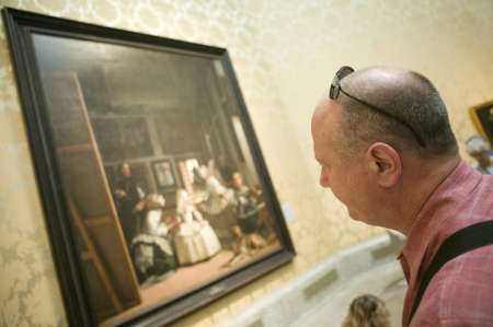 Man looks at Las Meninas by Velazquez as shown in the Museum de Prado, Prado Museum, Madrid, Spainのeditorial素材
