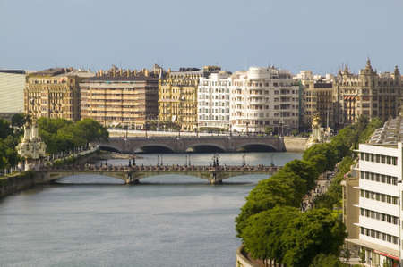 Apartment buildings line the river of Urumea beyond the Maria Cristina Bridge in the Spanish resort town of San Sebastian-Donostia, Basque region of Spainのeditorial素材