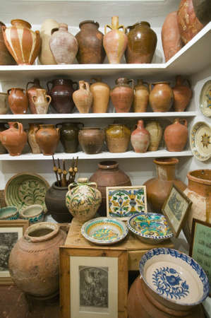 Pottery store shows stacks of old pots in old part of Centro, Sevilla Spainのeditorial素材