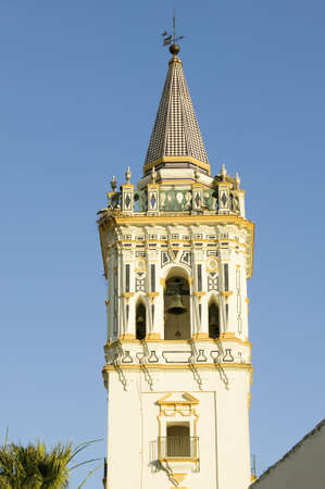Storks nest on white cathedral tower with beautiful sunlight in village of Southern Spain off highway A49 west of Sevillaのeditorial素材