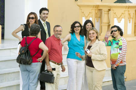 Group of smiling people near front of church in village of Southern Spain off highway A49 west of Sevillaのeditorial素材