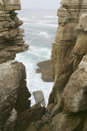 Atlantic ocean sprays water on rocks at Cruz do Remedios, near Peniche, west coast of Portugalのeditorial素材