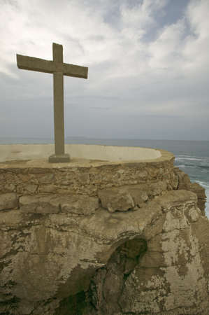 Cross overlooks Atlantic Ocean at Cruz do Remedios, near Peniche, west coast of Portugalのeditorial素材
