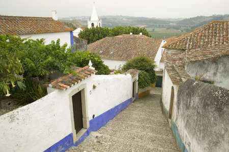 Narrow village streets of Obidos founded by the Celts in 300 BC, Portugalのeditorial素材