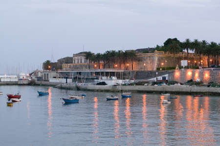 Colorful boats at sunset in Cascais, the popular seaport north of Lisbon/Lisboa Portugalのeditorial素材