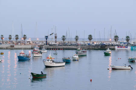 Colorful boats at sunset in Cascais, the popular seaport north of Lisbon/Lisboa Portugalのeditorial素材