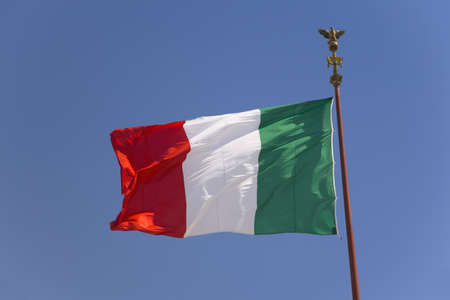 Italian flag flying in blue sky, Rome, Italy, Europe