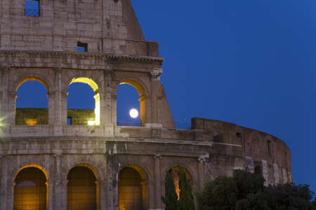 Full moon rising over the Colosseum or Roman Coliseum at dusk, originally the Flavian Amphitheatre, an elliptical amphitheatre in the centre of the city of Rome, the largest ever built in the Roman Empire, Rome, Italy, Europeのeditorial素材