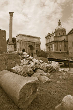 Sepia image of Roman ruins with Column of Foca with Roman Forum in background in Rome, Italy, Europeのeditorial素材