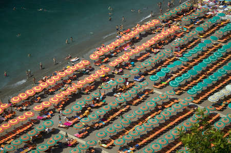 Elevated pattern view of famous beach umbrellas of Amalfi, a town in the province of Salerno, in the region of Campania, Italy, on the Gulf of Salerno, 24 miles southeast of Naplesのeditorial素材