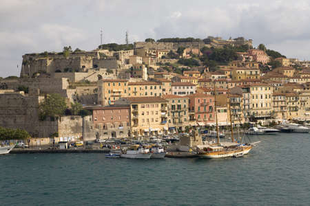 Water view of colorful buildings and harbor of Portoferraio, Province of Livorno, on the island of Elba in the Tuscan Archipelago of Italy, Europe, where Napoleon Bonaparte was exiled in 1814のeditorial素材