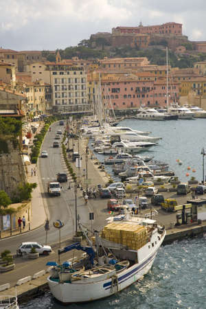 Water view of colorful buildings and harbor of Portoferraio, Province of Livorno, on the island of Elba in the Tuscan Archipelago of Italy, Europe, where Napoleon Bonaparte was exiled in 1814のeditorial素材