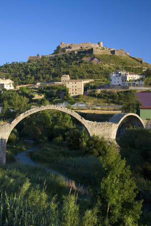 Ancient stone arch bridges with a background of Parador de Cardona, a 9th Century medieval hillside Castle, near Barcelona, Catalonia, Cardona, Spainのeditorial素材
