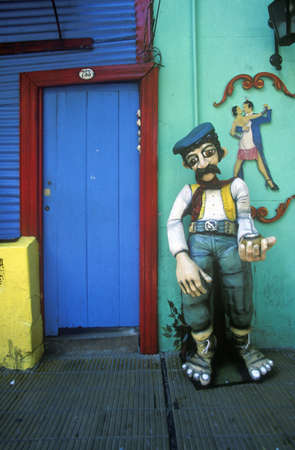 Art statue and blue door at entrance of Ala Boca, art area for tourists in Buenos Aires, Argentinaのeditorial素材