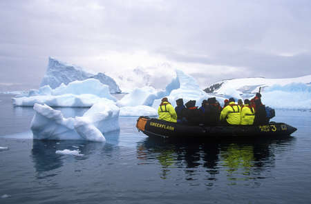 Ecological tourists in inflatable Zodiac boat in Paradise Harbor, Antarcticaのeditorial素材