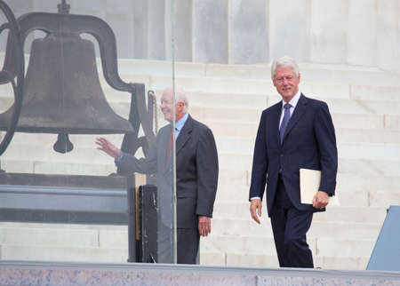 Former presidents Jimmy Carter and Bill Clinton arrive for the ceremony to commemorate the 50th anniversary of the March on Washington for Jobs and Freedom August 28, 2013 in Washington, DC. のeditorial素材
