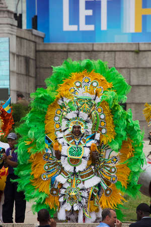 Dancer in green feathered ethnic costume performs at the 50th Anniversary of the March on Washington...