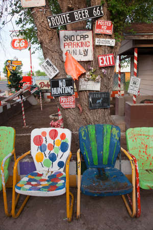Multi-colored chairs with humorous signs, Route 66, Seligman, Arizona