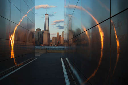 Empty Sky: Jersey City 911 Memorial at sunset shows One World Trade Center 1WTC, Freedom Tower through golden circle of light, New Jersey, USAのeditorial素材