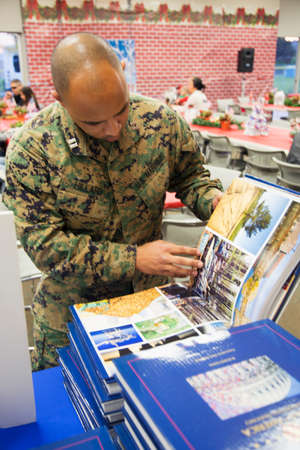 Soldier looks at Visions of America book at Christmas dinner, Wounded Warrior Center, Camp Pendleton, North of San Diego, California, USAのeditorial素材