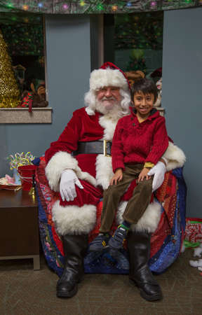 Little boy sits on Santa's lap at Christmas dinner for US Soldiers at Wounded Warrior Center, Camp Pendleton, North of San Diego, California, USAのeditorial素材